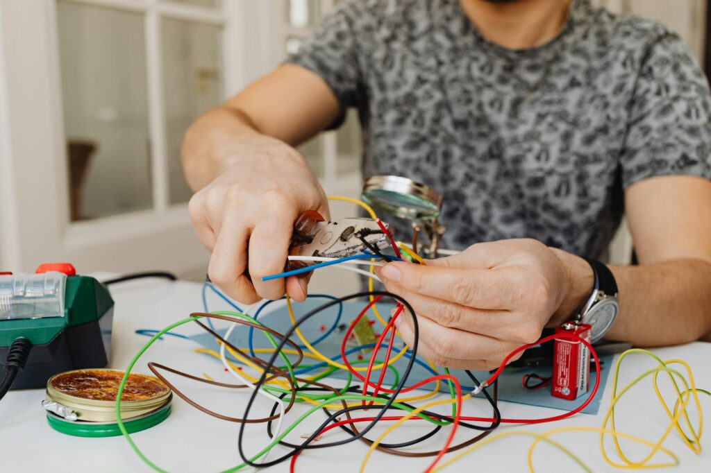 close-up electrical wiring terminal hands
