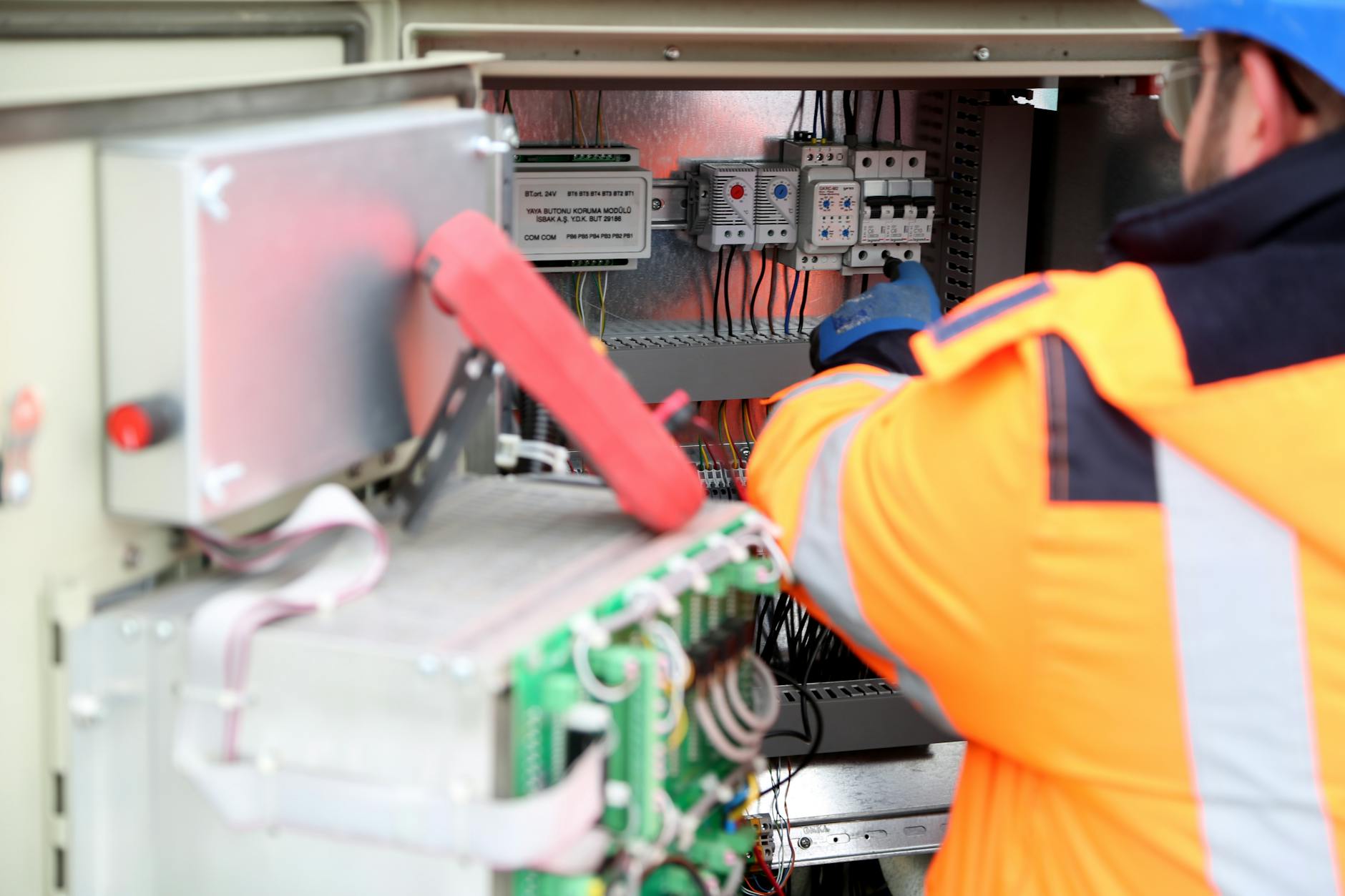 close-up hand electrician installing circuit breaker panel