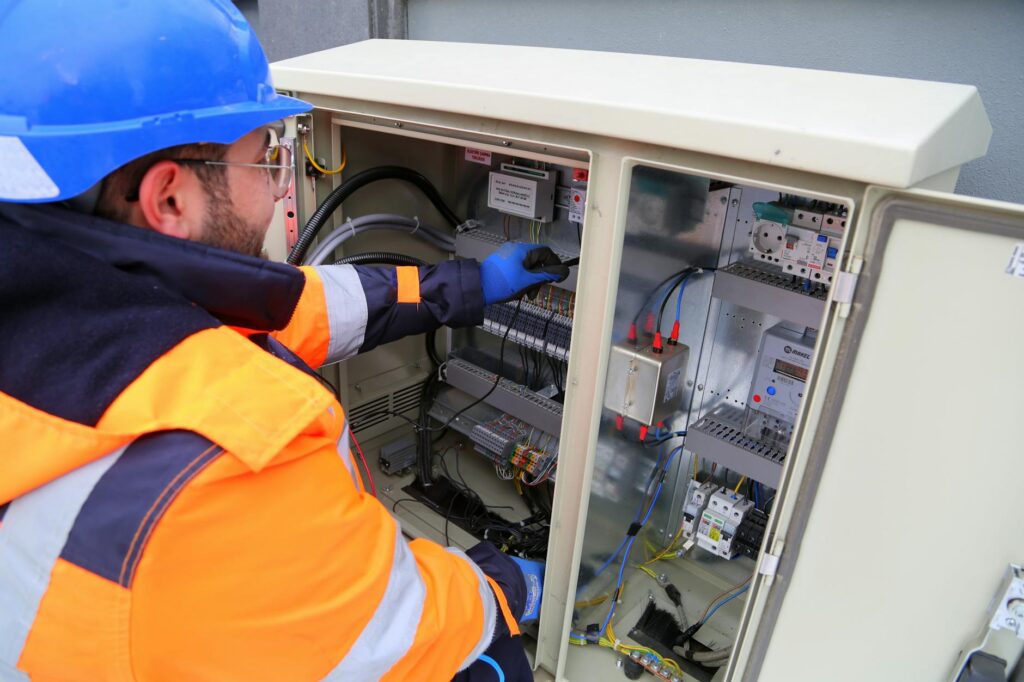electrician inspecting home circuit breaker panel​
