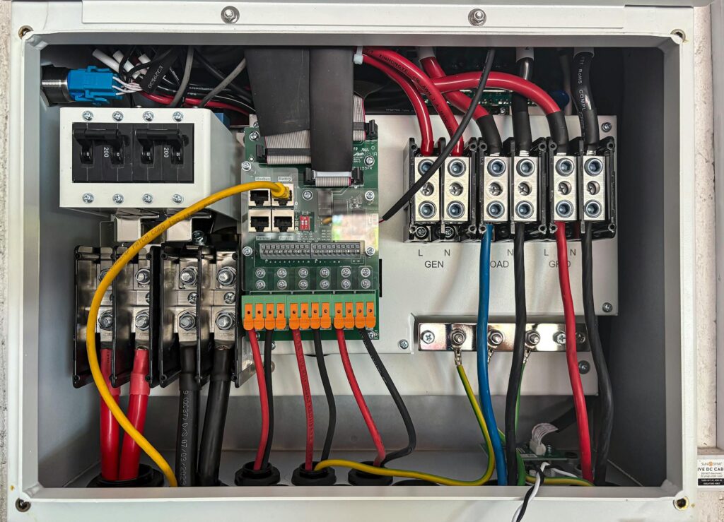 electrician inspecting home circuit breaker panel with multimeter and wiring