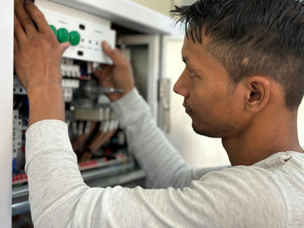 electrician installing residential wiring panel and circuit breaker​