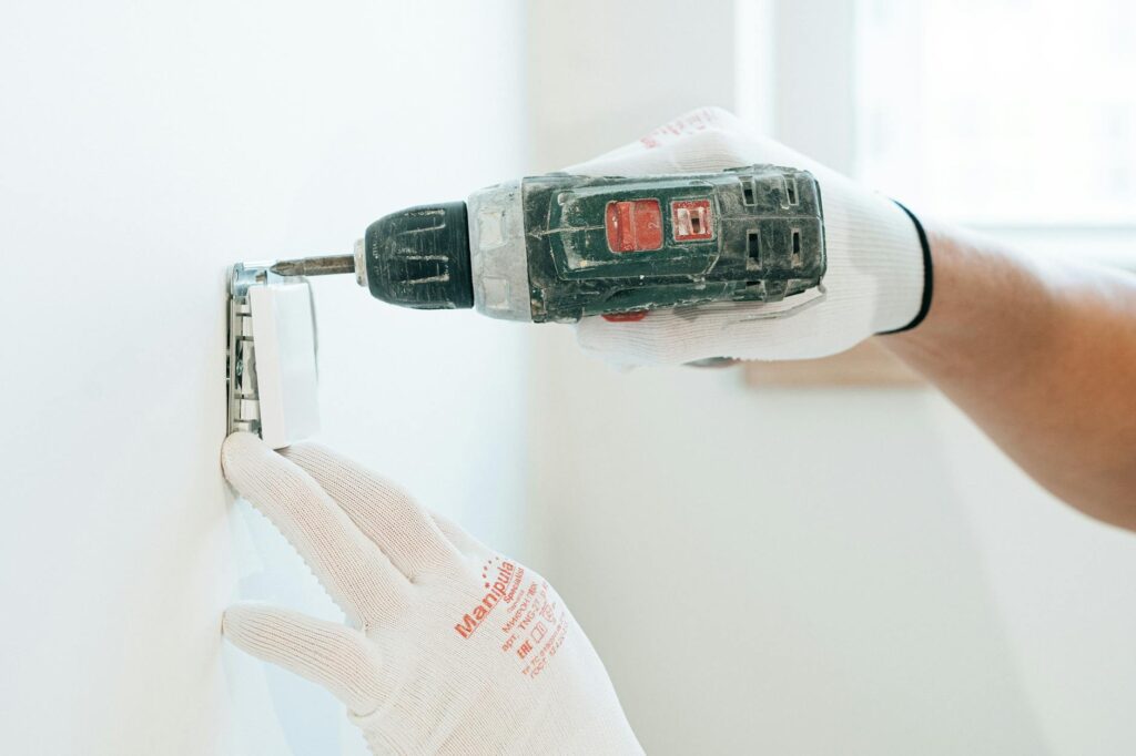 electrician testing low voltage outlet in a home setting