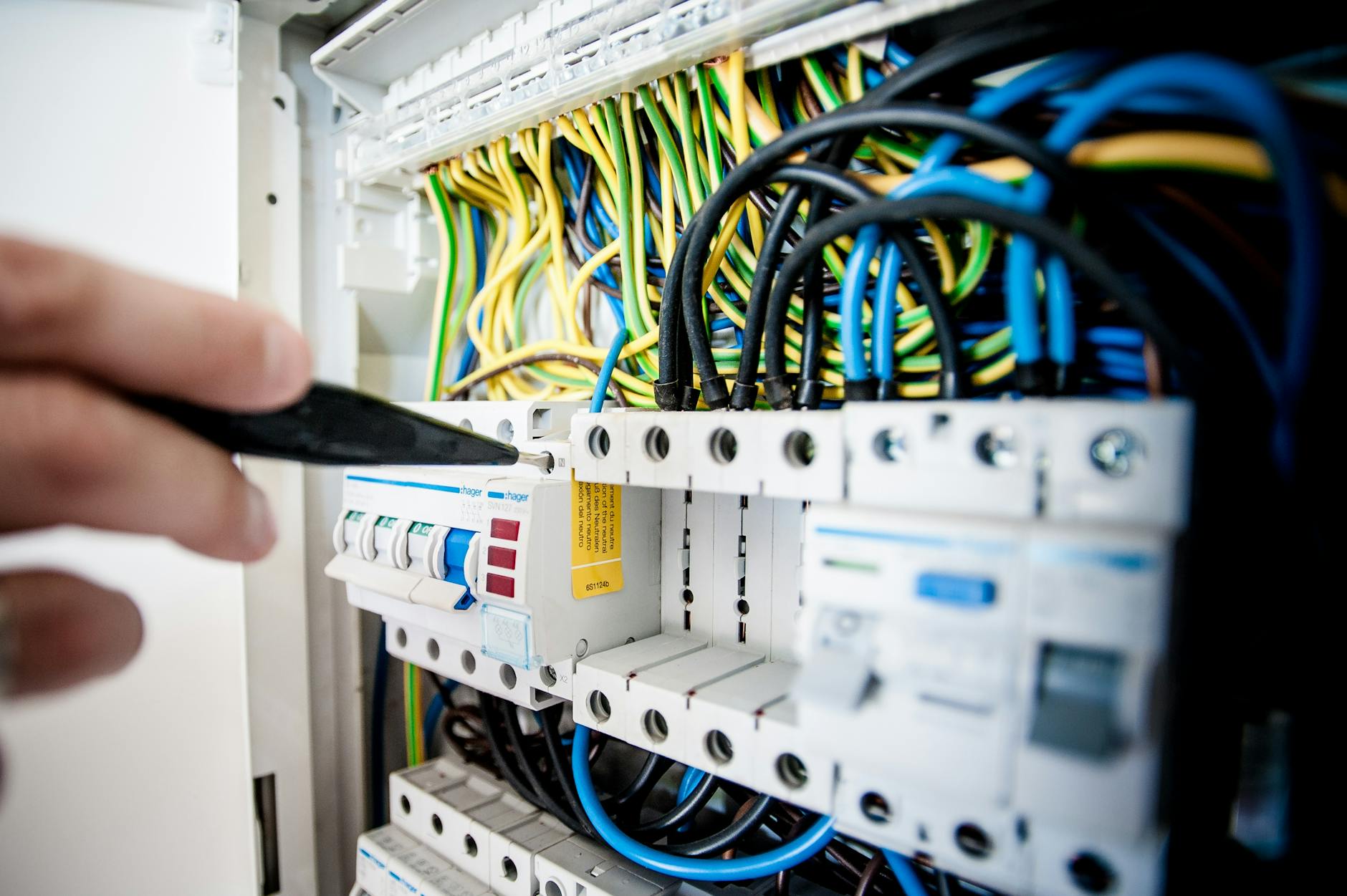 close-up electrician installing electrical outlet terminals