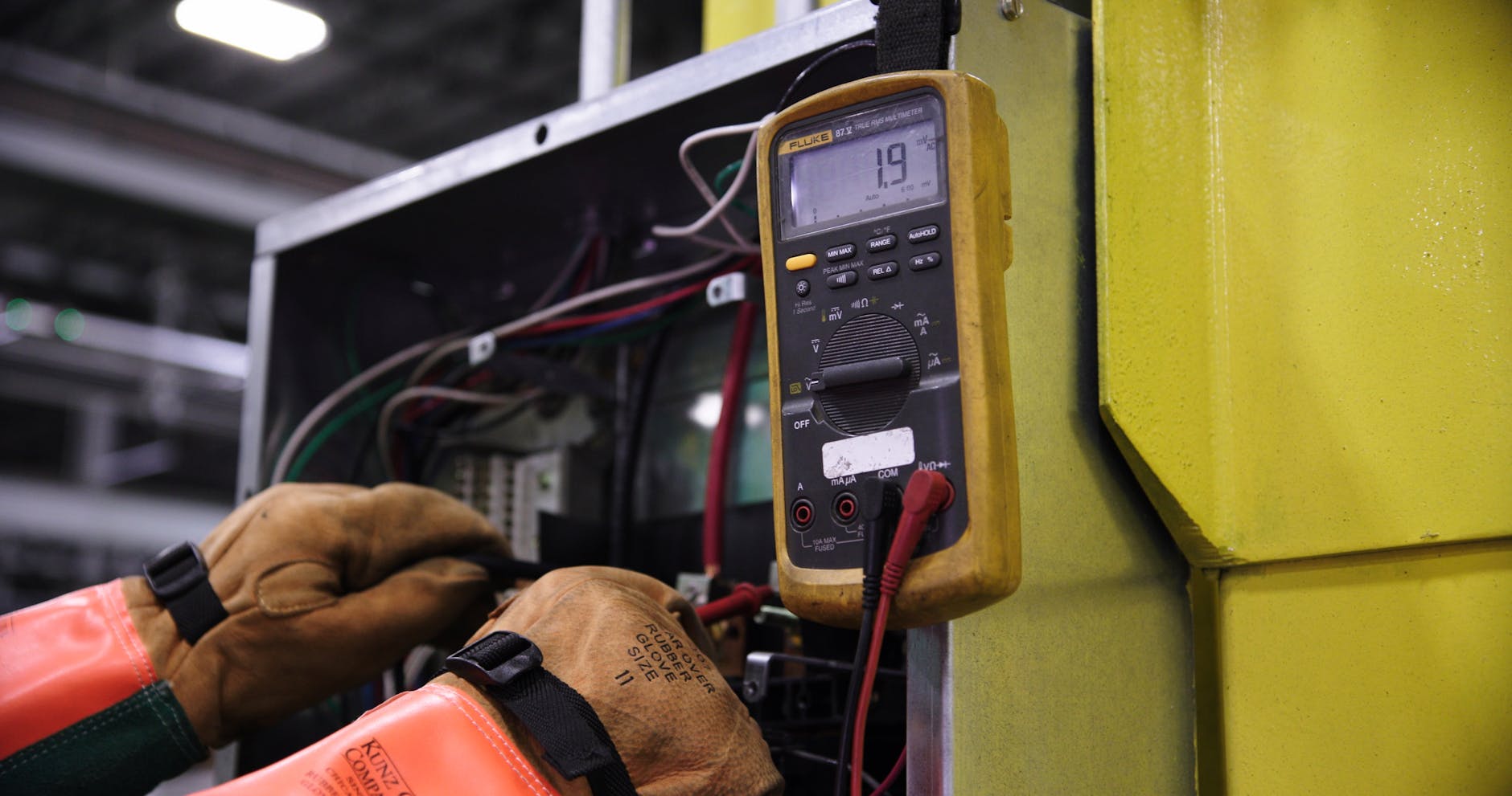 electrician checking wiring panel
