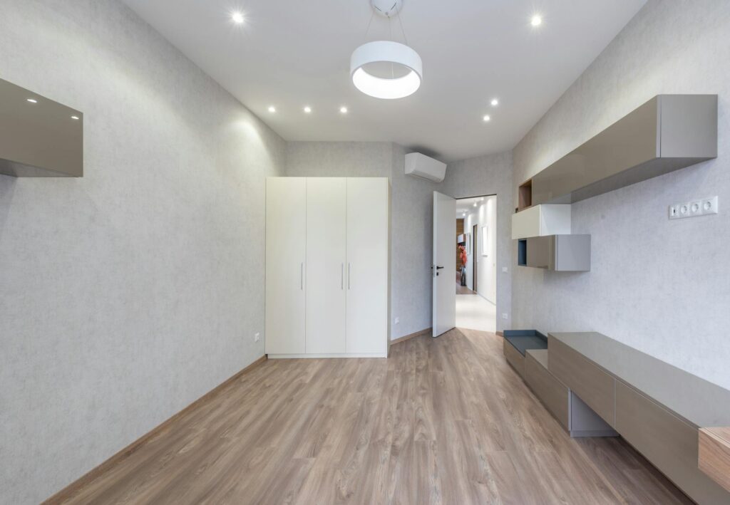 electrician installing LED ceiling lights in modern living room