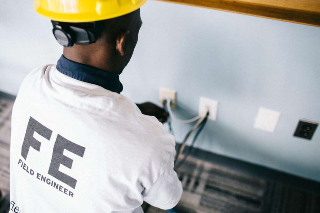 electrician installing safe water heater wiring in bathroom