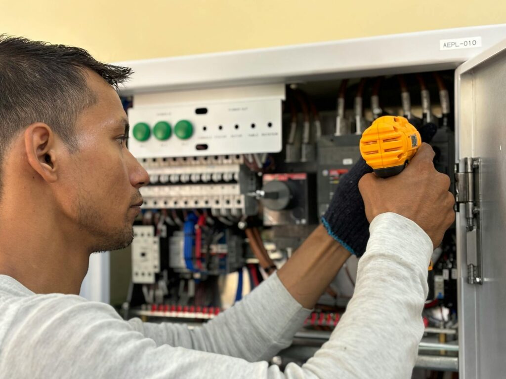 electrician repairing MCB panel in hot climate